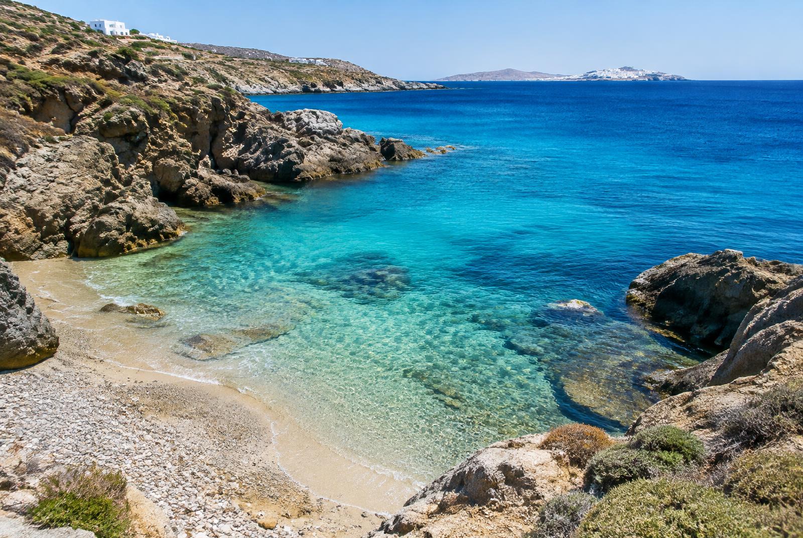 Clear turquoise water in a rocky cove on the Mykonos coast